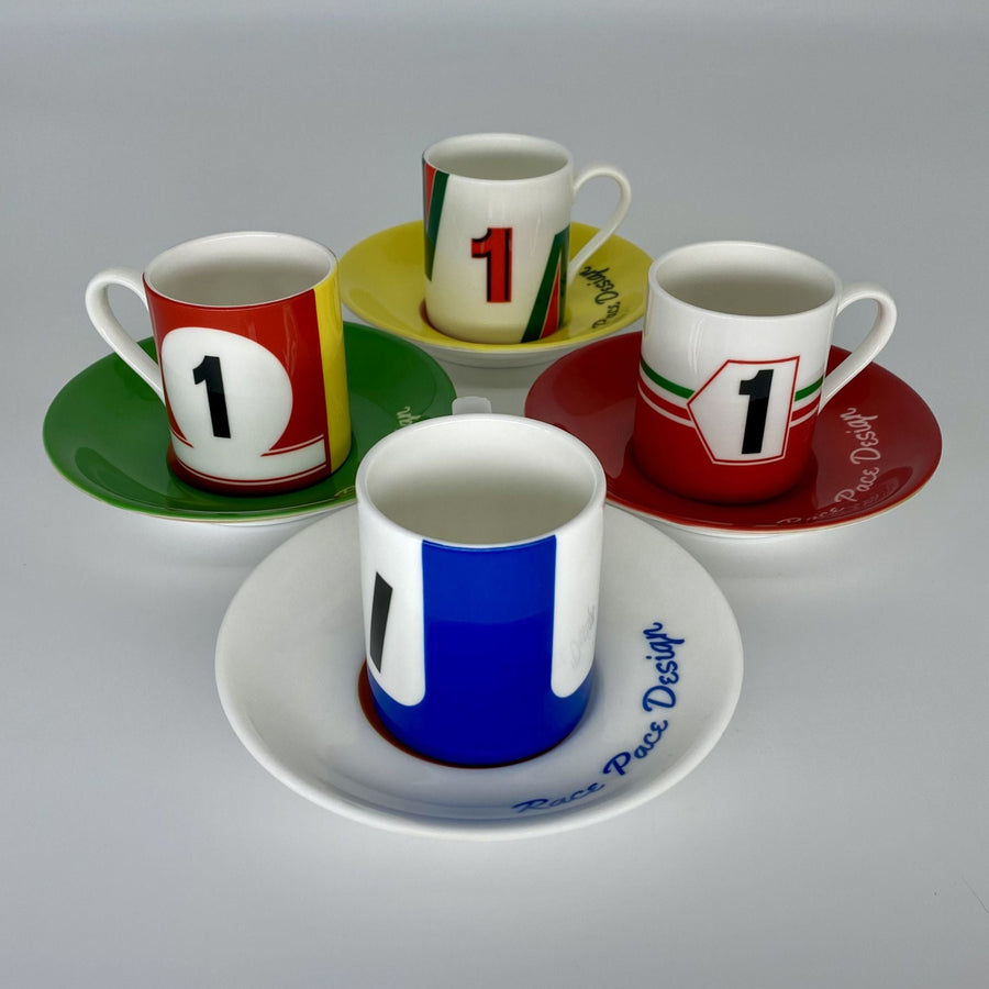 Set of four colorful coffee cups and saucers with number '1' design on a gray background