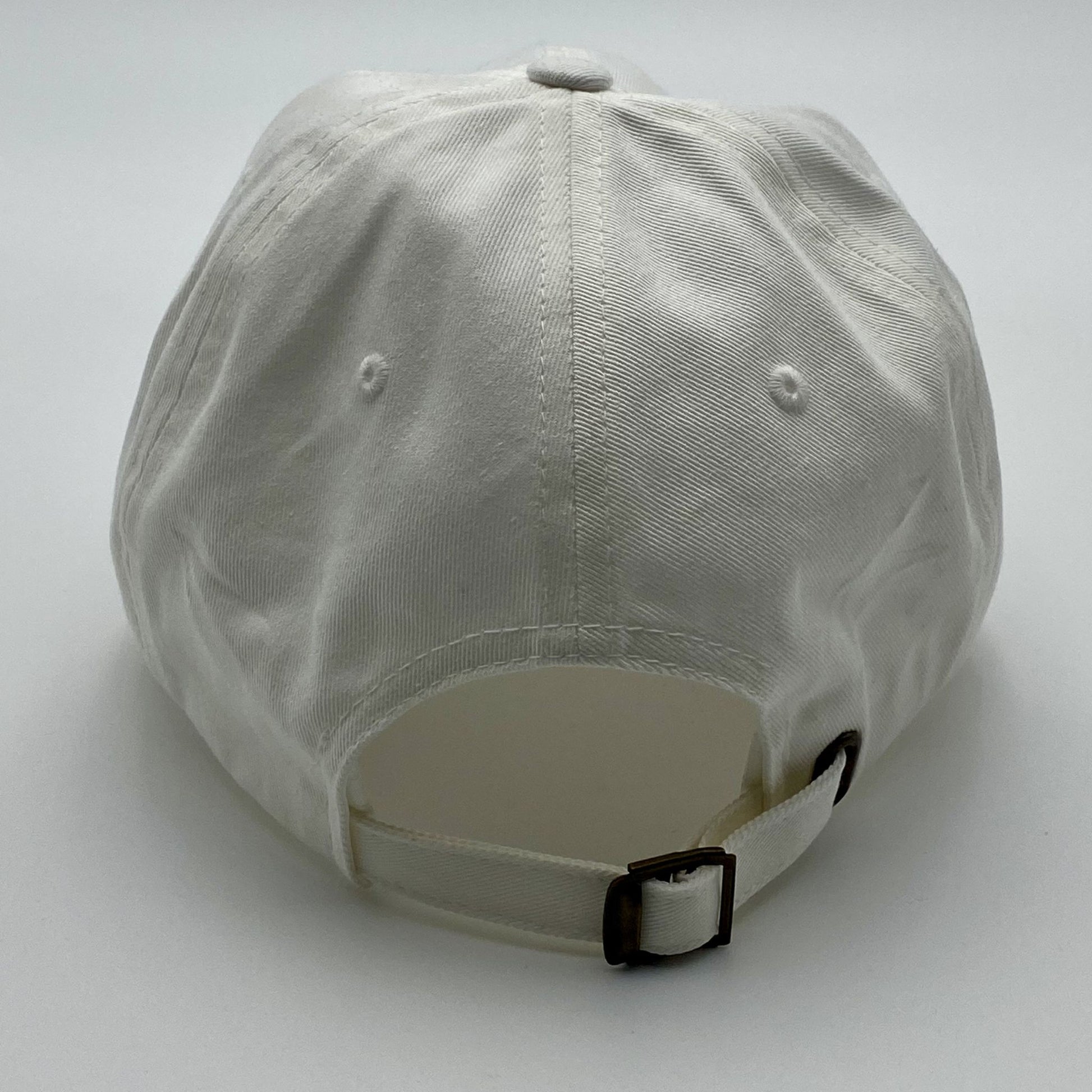 Back view of a white cap with an adjustable strap on a white background