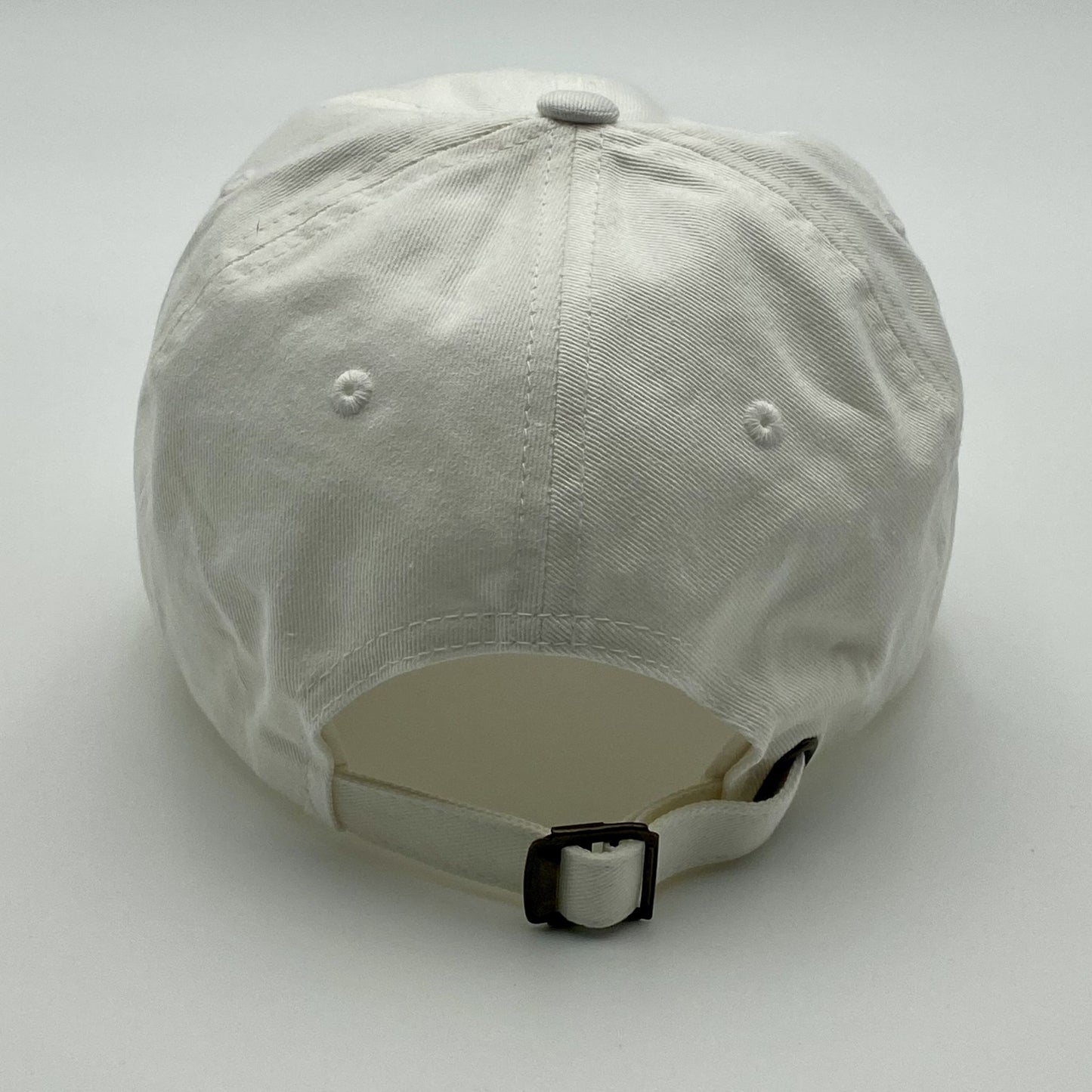 White adjustable hat on a light gray background
