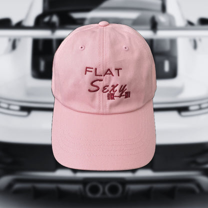 Pink cap with 'FLAT Sexy' text on a blurred car background