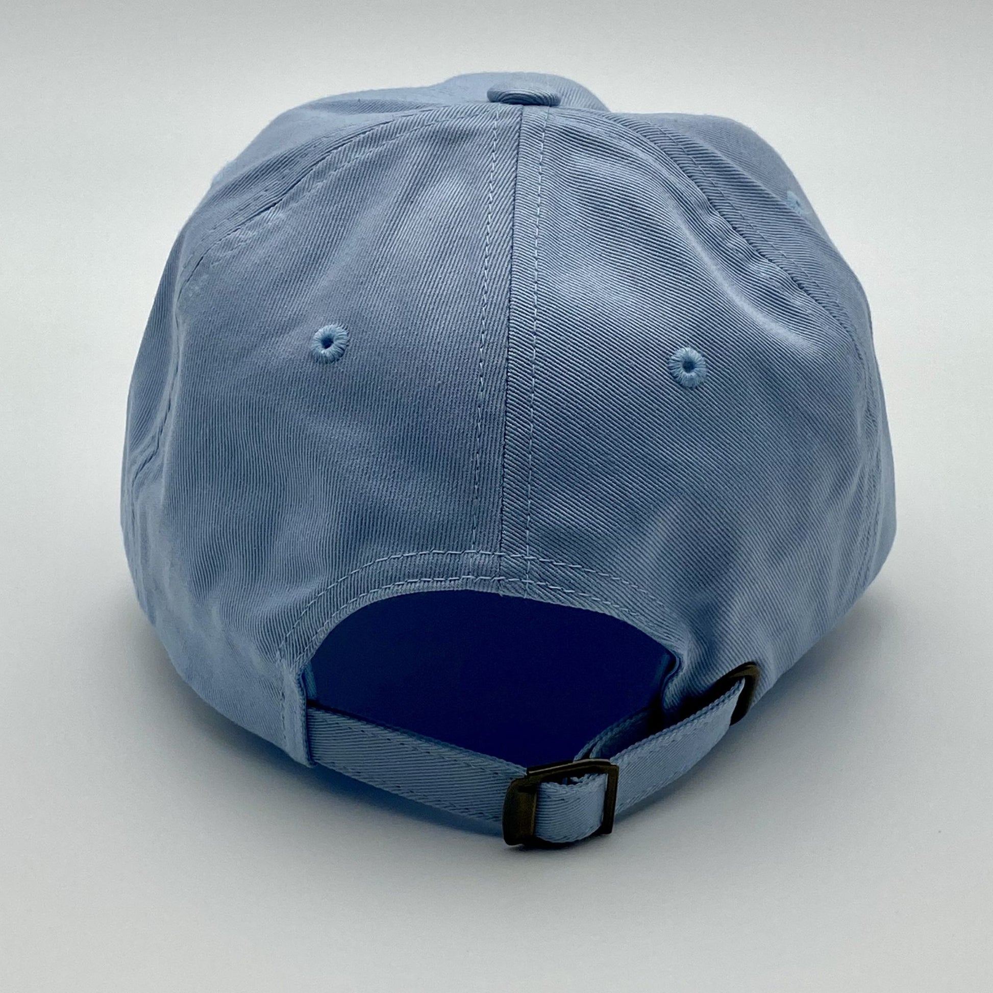 Blue racing cap with adjustable buckle on a light gray background