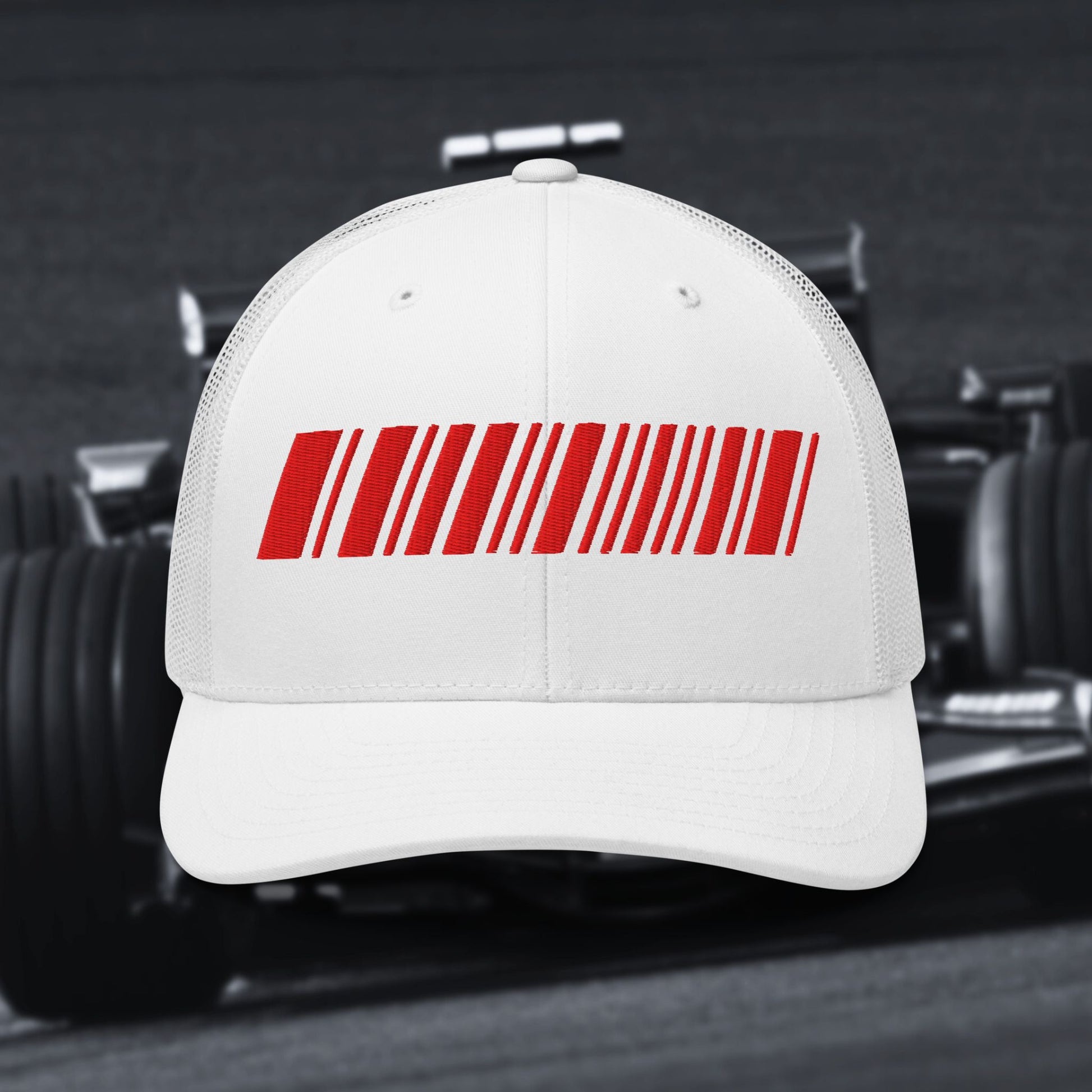 White cap with a red barcode design on a blurred background