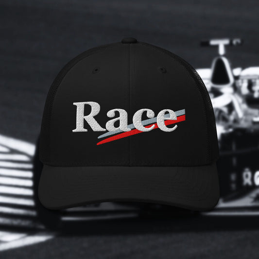Black cap with 'Race' text in white with silver and red stripes on a blurred race car background