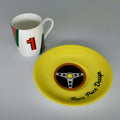 White cup with red and green design and number 1, next to a yellow saucer with steering wheel graphic and 'Race Pace Design' text on a gray background.