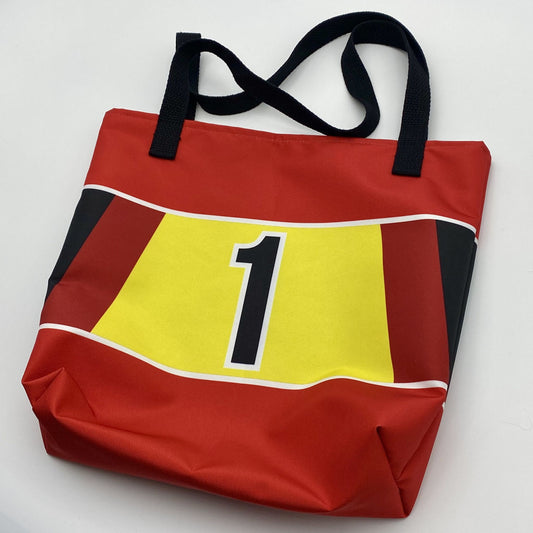 Red tote bag with a black, red and yellow design and black number '1' on a white background