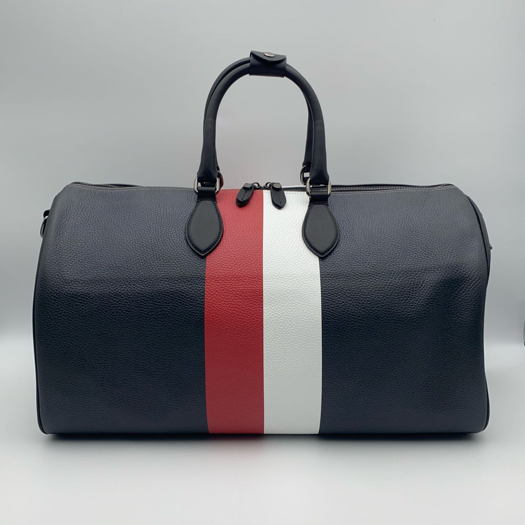 Black duffle bag with red and white stripes on a white background