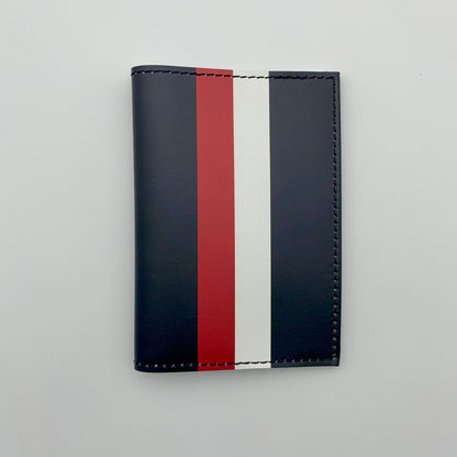 Black passport cover with red, and white stripes on a white background