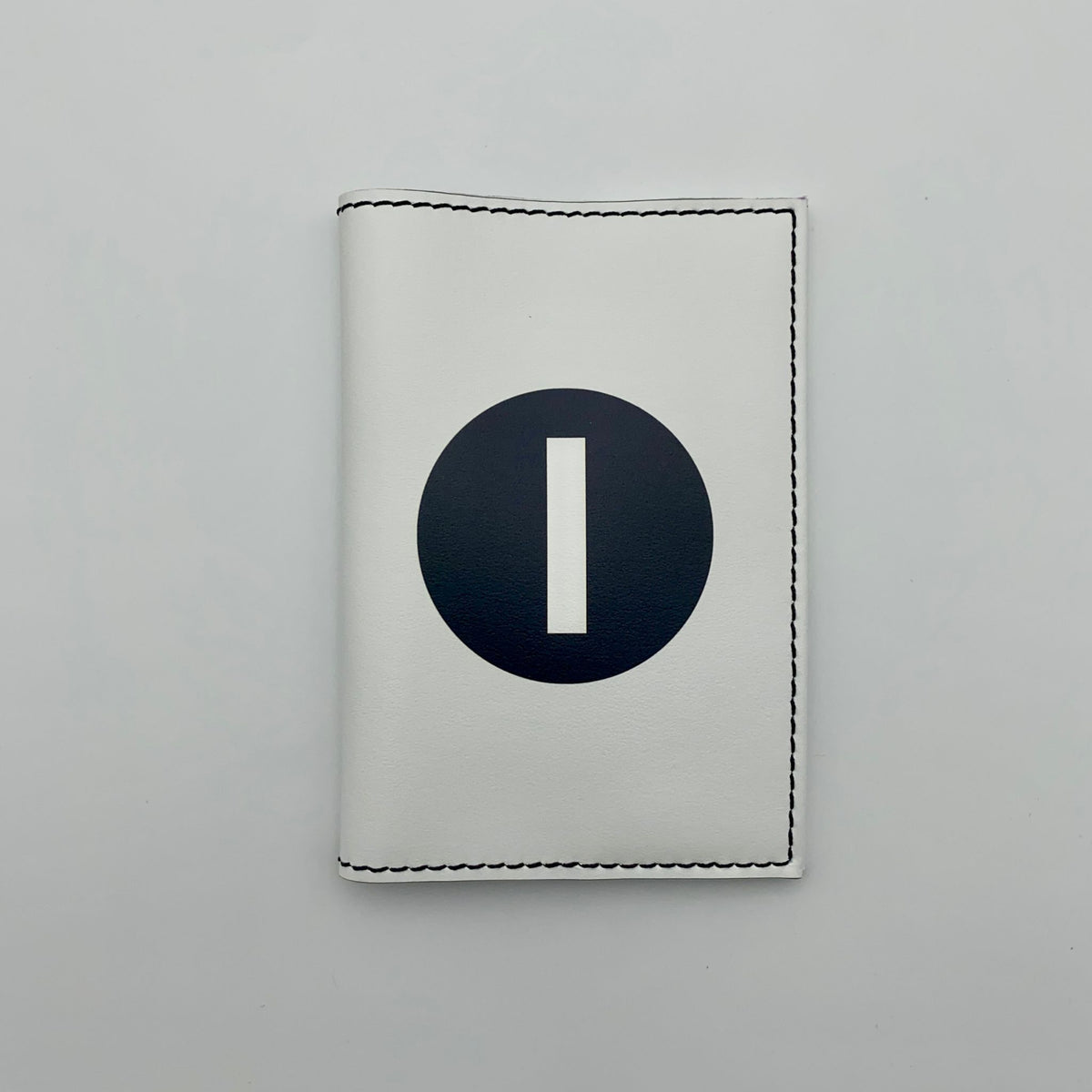 White passport cover with a white number "1" in black circle on a white background