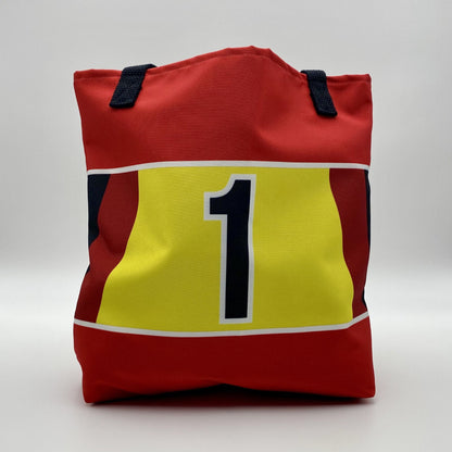 Red bag with a yellow square and black number one on a white background