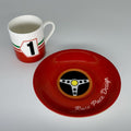 Red plate with steering wheel design and cup with number 1 on a gray background