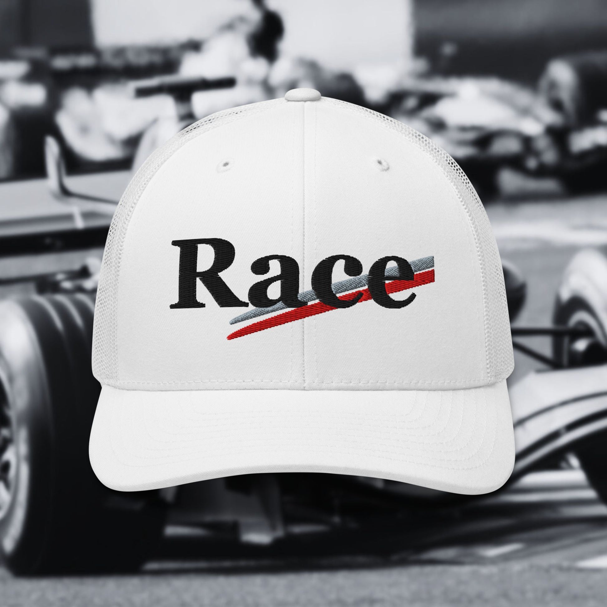 White cap with 'Race' text in front of a blurred racing background